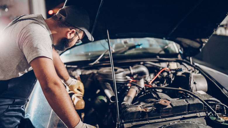 Mechanic looking at an engine