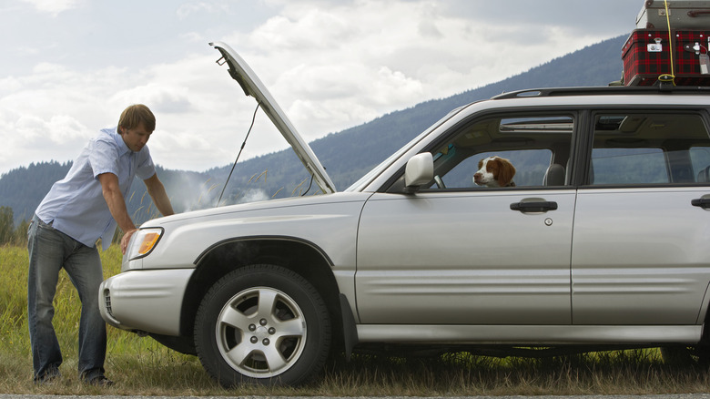 Man stands with overheated car