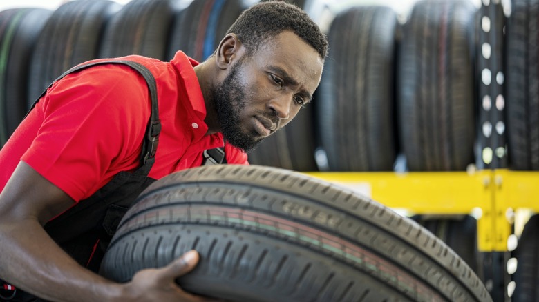 Specialist examining tire