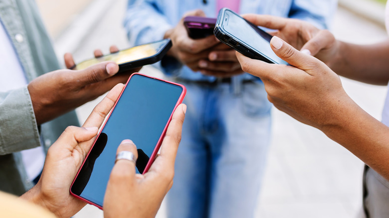 A group of people using their phones