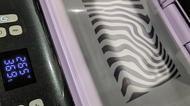 HTVRONT heat press with lid open and sublimation film in place