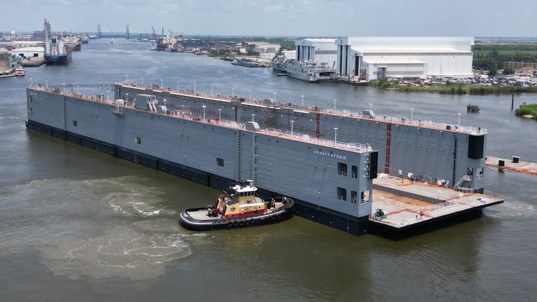 The Navy's Auxiliary Floating Dry Dock Medium (AFDM) being moved via tug