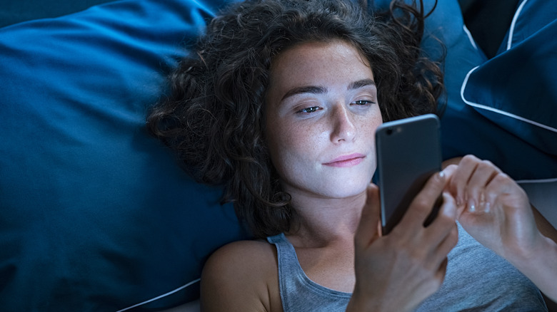 woman using phone at night