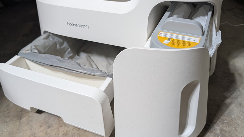 Waste bins for kitty litter machine opened.