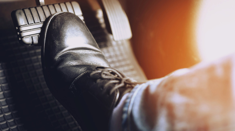 Foot pressed on brake pedal