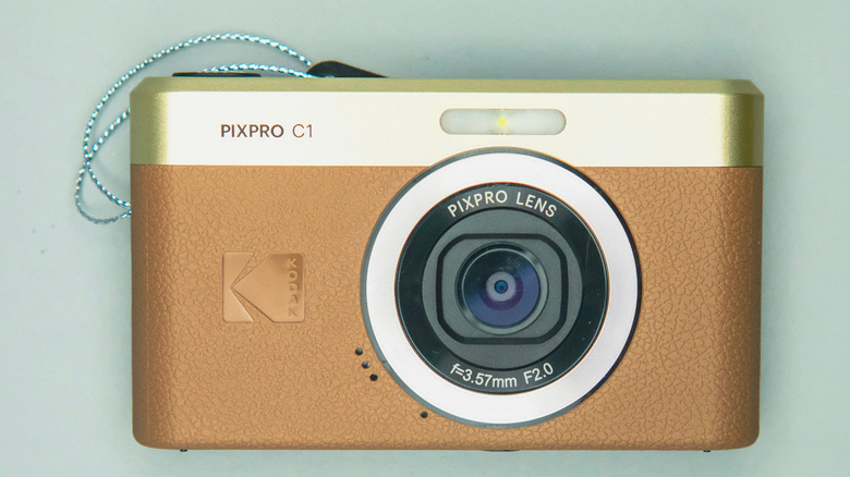 The Kodak PIXPRO C1 camera in brown on a green background
