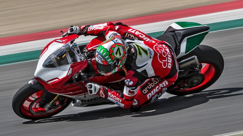 A Ducati 1299 Panigale R Final Edition at speed on a closed course, rider leaning left