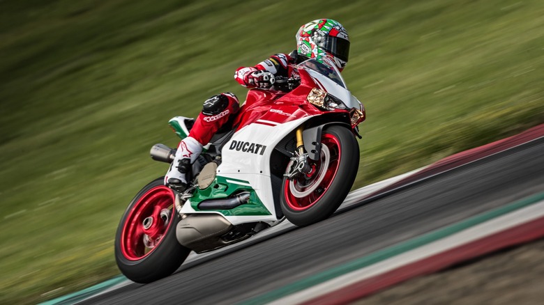 A professional rider aboard the Ducati 1299 Panigale R Final Edition, leaning left