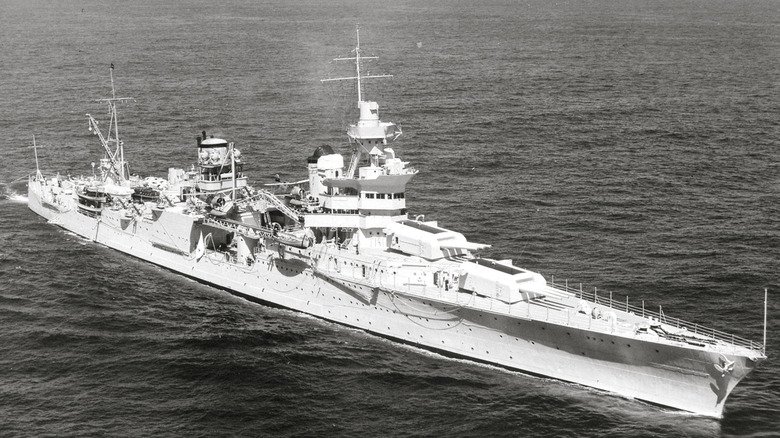 Black and white photo of the USS Indianapolis underway in the ocean in 1939 with an angled perspective.