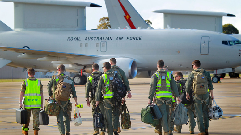 Members of the Australian Air Force march towards an E-7.