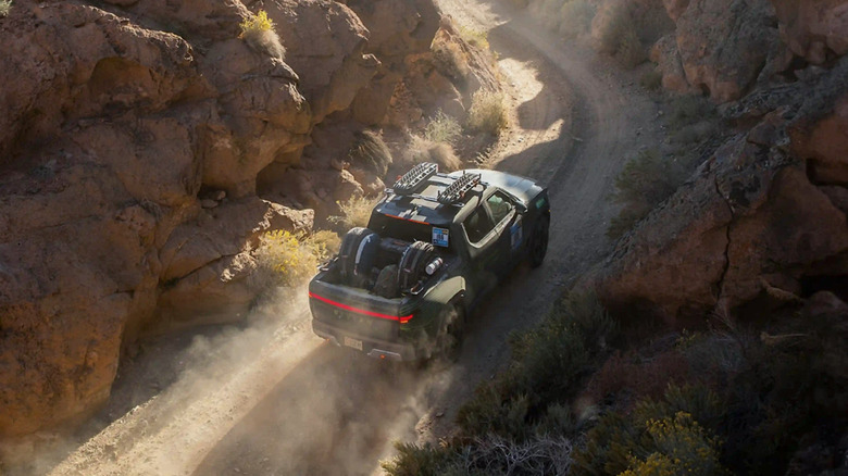 Rivian pickup truck driving through a mountain pass