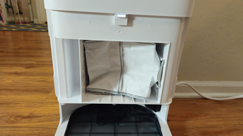 The Yeedi M14 Plus dust bag hidden behind a door on the Omni Smart Station