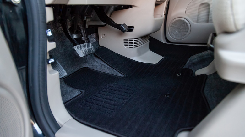 Carpet on the floor of a car cabin.