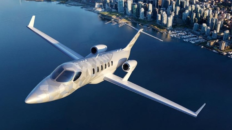 Depiction of the new Hondajet Echelon business jet taking off over a city