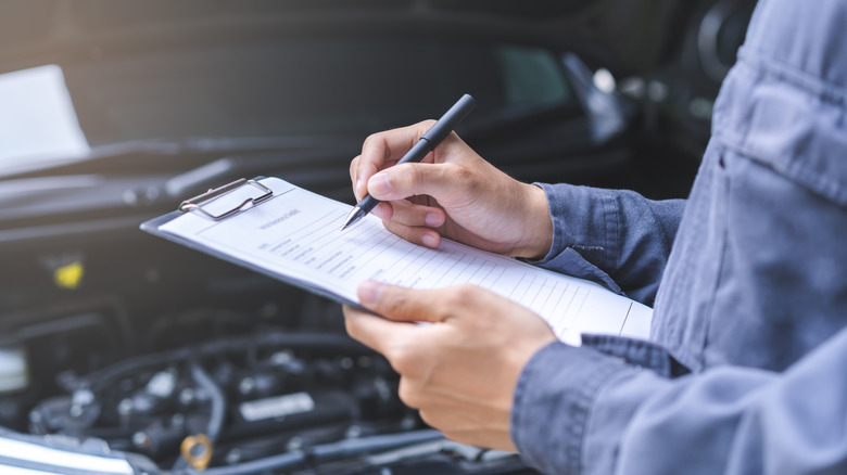Repair technician filling out paperwork