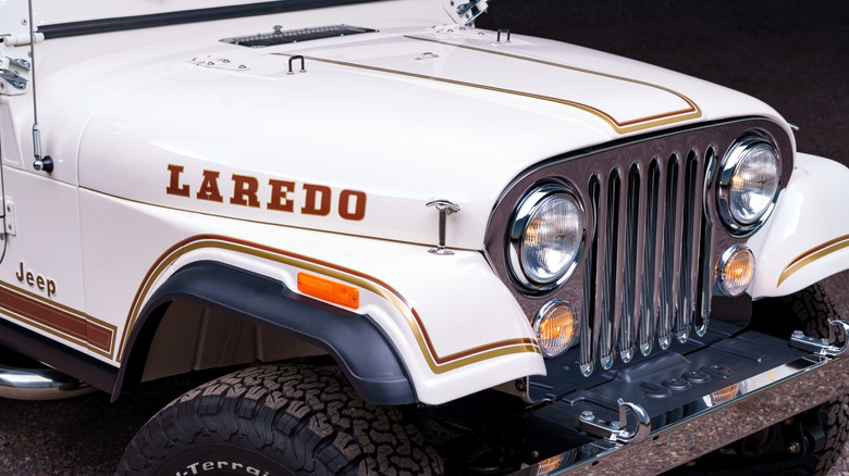 A close-up of the Laredo nameplate on a white Jeep