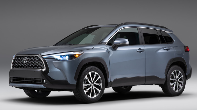 Front 3/4 view of 2022 Toyota Corolla Cross in studio