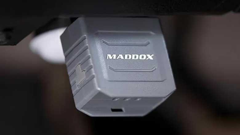 A Bluetooth code reader connected to a vehicle.