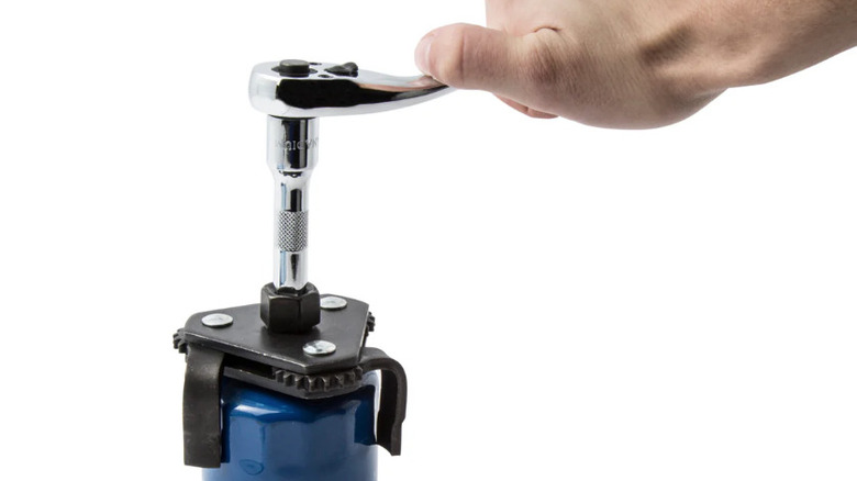 A worker using a ratchet to tighten a Steelman oil filter wrench