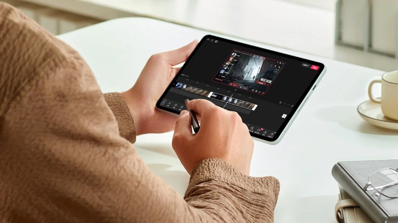 Person using RedMagic Astra tablet to edit video