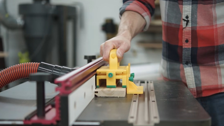 A GRR-RIPPER 2GO push block being used with a table saw