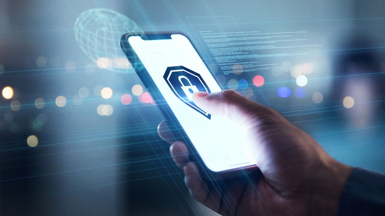 A person holding a phone with secure lock symbol on its screen