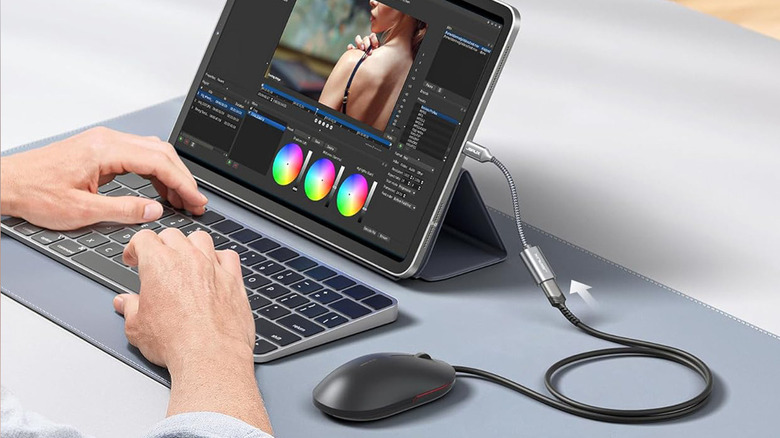 person working on a tablet with peripherals attached using a USB OTG adapter