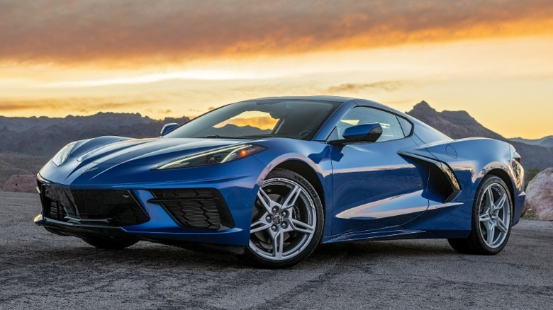 Blue 2020 Chevrolet Corvette Stingray parked on a desert road at sunset