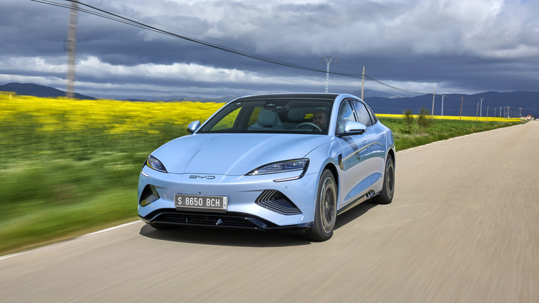 Blue BYD Seal running with beautiful scenes behind