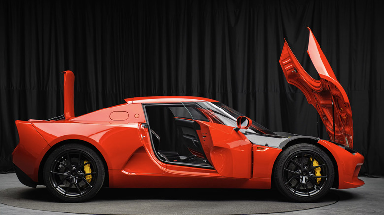 A red SC01 seen in profile with the hood, doors, and trunk open