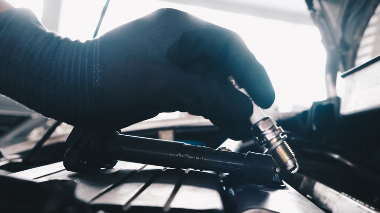 Removing spark plug from ICE car engine