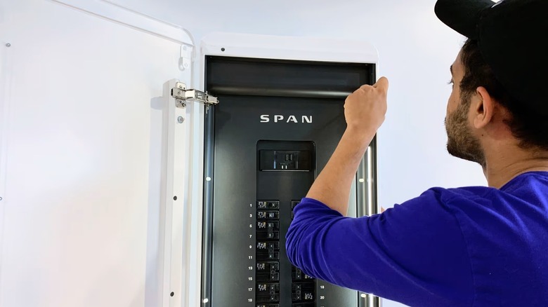A SPAN technician working on a domestic SPAN electrical control panel
