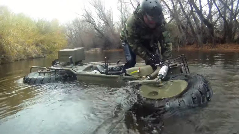 Tim Ralston floating a a Rokon Trail-Breaker across water.