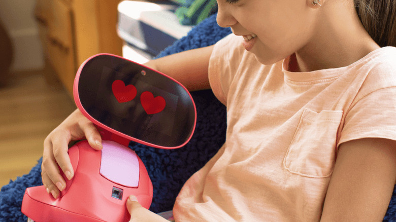 child holding Miko 3 robot 