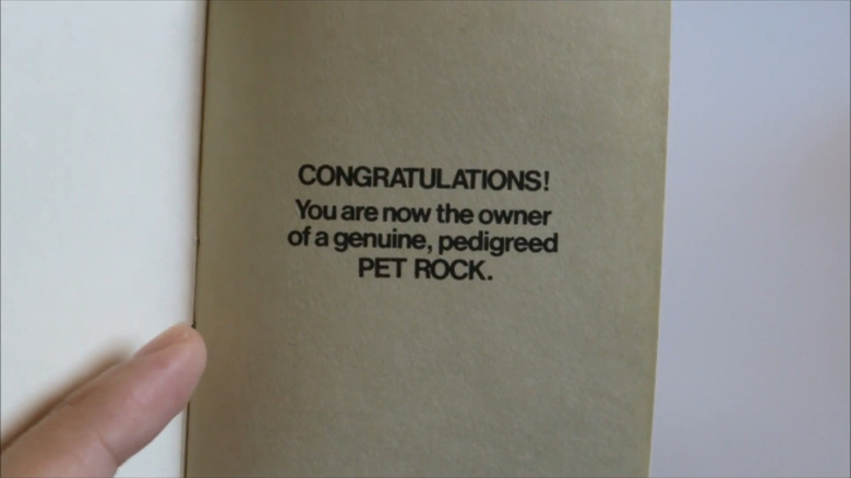 A page from Gary Dahl's Pet Rock manual stating "Congratulations! You are now the owner of a genuine, pedigreed Pet Rock".