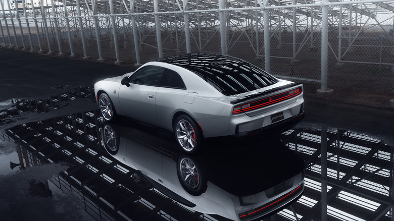 Dodge Charger Daytona Scat Pack in silver in an industrial setting, rear 3/4 view