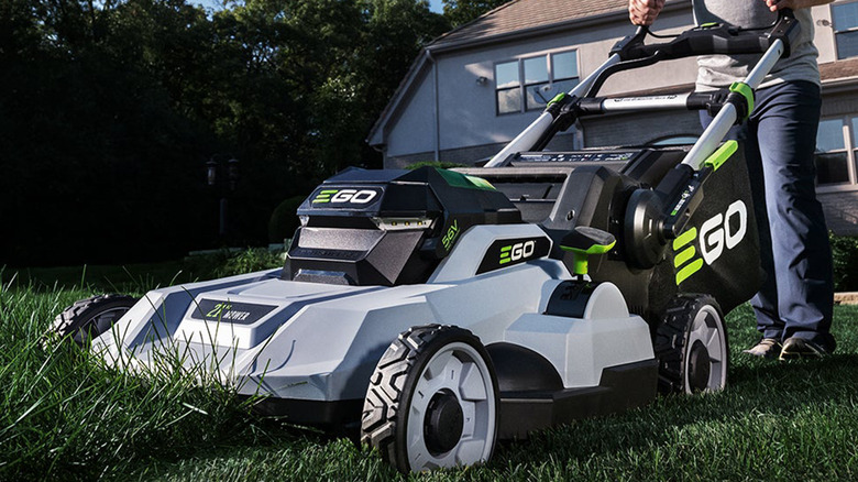 A close-up of the Power+ Push Mower 21" Kit being used, front 3/4 view