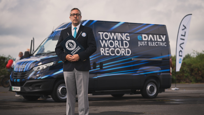 Guinness World Records official standing in-front of Iveco eDaily van