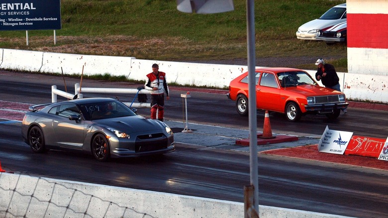 Nissan GTR R35 and Chevy Chevette at a drag strip starting line