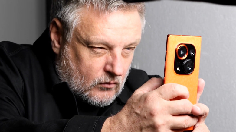 A photographer using the Tecno Phantom X2 Pro. 