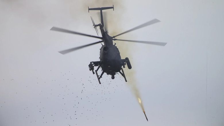 AH-6 Little Bird firing a rocket, seen from below