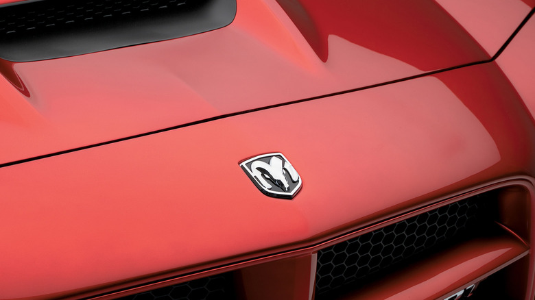 Close-up of Dodge logo on a red Dodge Charger SRT8.