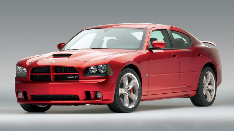 Studio photo of red Dodge Charger SRT8 with a gray backdrop.