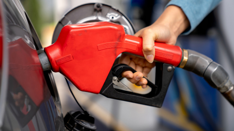 Woman pumping gas