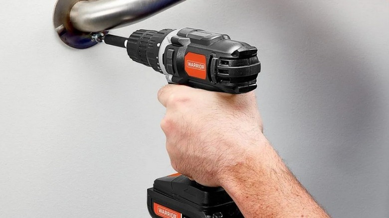 Person driving rail-mount screw with Warrior 18V Cordless ⅜-inch Drill