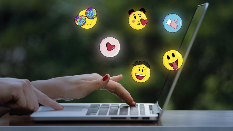 laptop with emojis flying out
