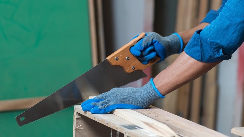 cutting wood with a handsaw