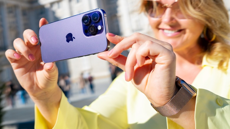 woman taking photos with iphone