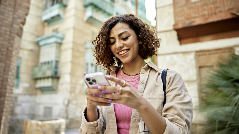 woman using iphone while traveling