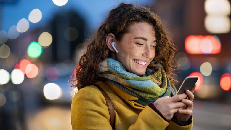 smiling person with smartphone